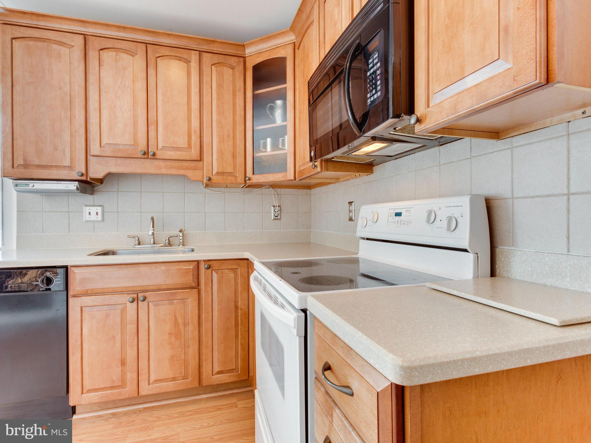 7315 Inzer Street Springfield, VA 22151 - Photo 7 of 23 a kitchen with stainless steel appliances granite countertop a sink stove and cabinets