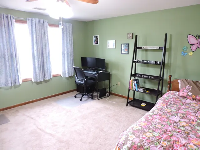 a bedroom with a workspace