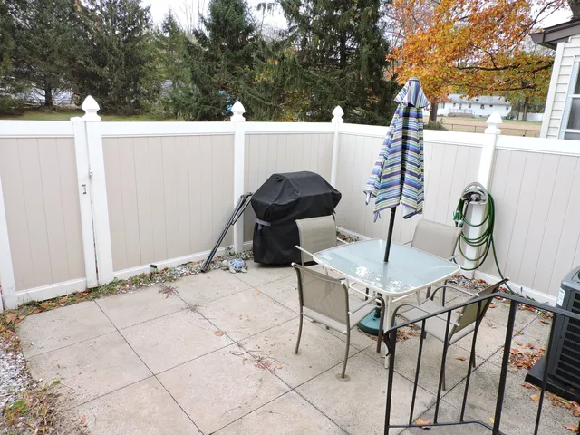 a view of a patio with iron fence