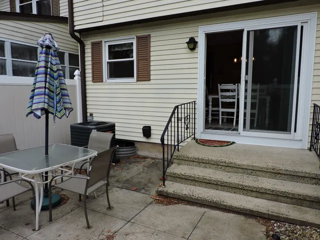 a view of a house with a table and chairs