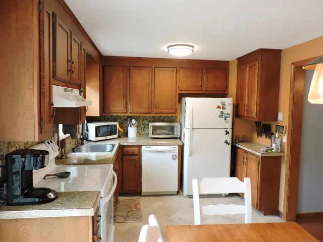 a kitchen with refrigerator cabinets and a sink