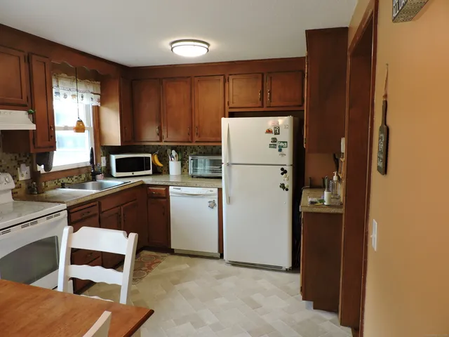 a kitchen with refrigerator cabinets and a sink