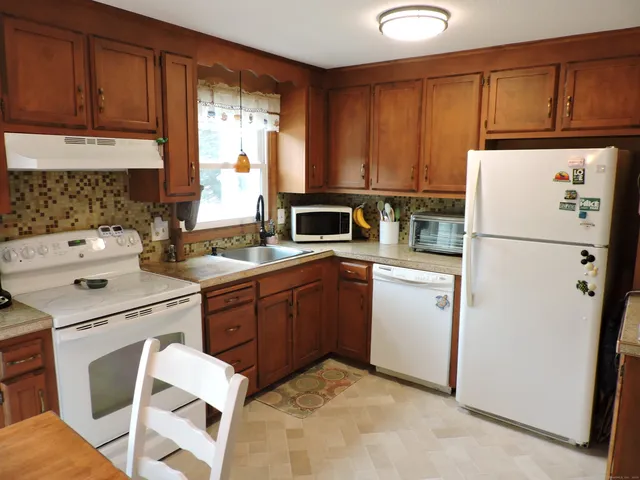 a kitchen with a refrigerator sink and stove