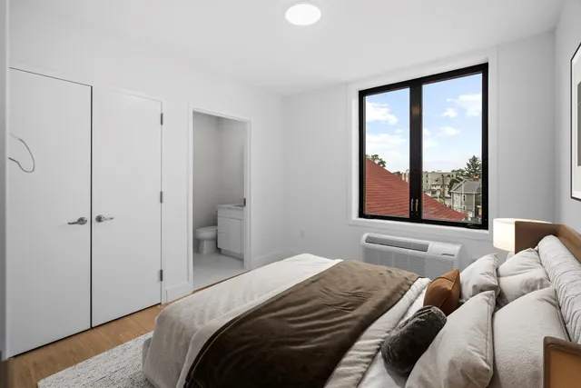 a bedroom with a bed and window