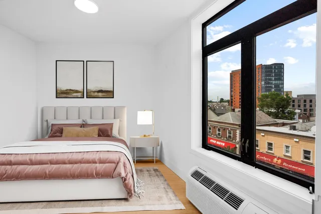 a bedroom with a bed and window