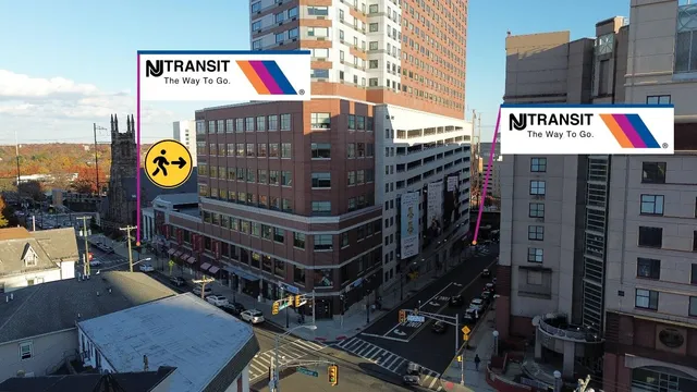 a sign board with buildings in the background