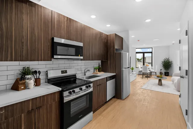 a kitchen with a refrigerator stove and microwave