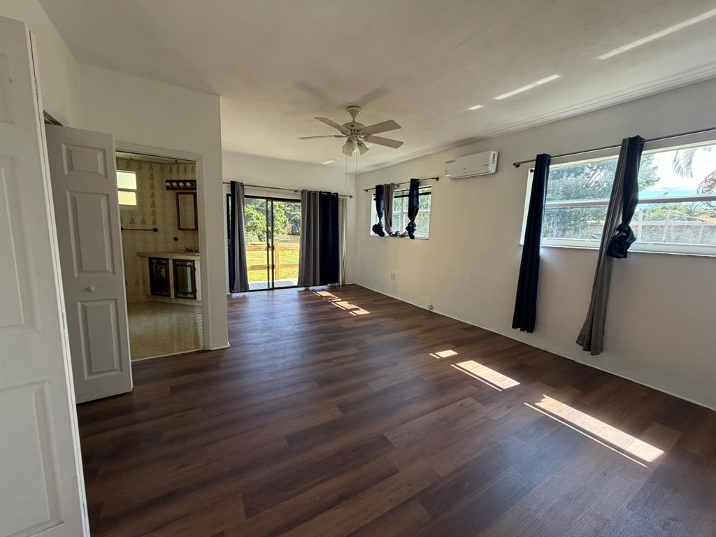 14131 Northwest 3rd Avenue, Unit F Miami, FL 33168 - Photo 1 of 7 wooden floor in an empty room with a window