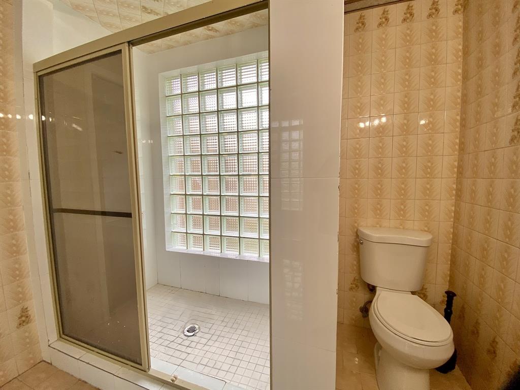 14131 Northwest 3rd Avenue, Unit F Miami, FL 33168 - Photo 2 of 7 a bathroom with a toilet and a shower