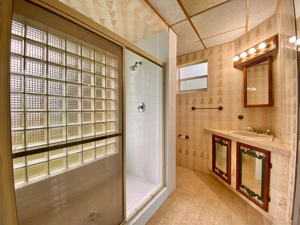 14131 Northwest 3rd Avenue, Unit F Miami, FL 33168 - Photo 3 of 7 a spacious bathroom with a granite countertop sink mirror and shower