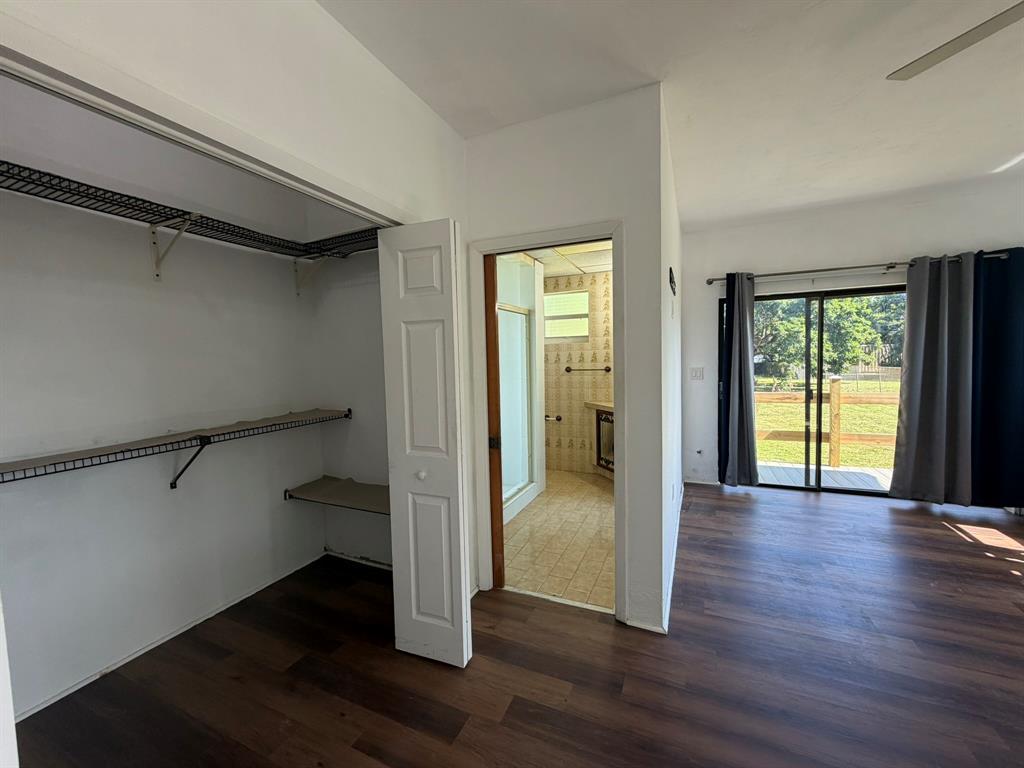 14131 Northwest 3rd Avenue, Unit F Miami, FL 33168 - Photo 6 of 7 an empty room with wooden floor and windows