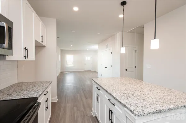 a kitchen with a stove kitchen island and stainless steel appliances
