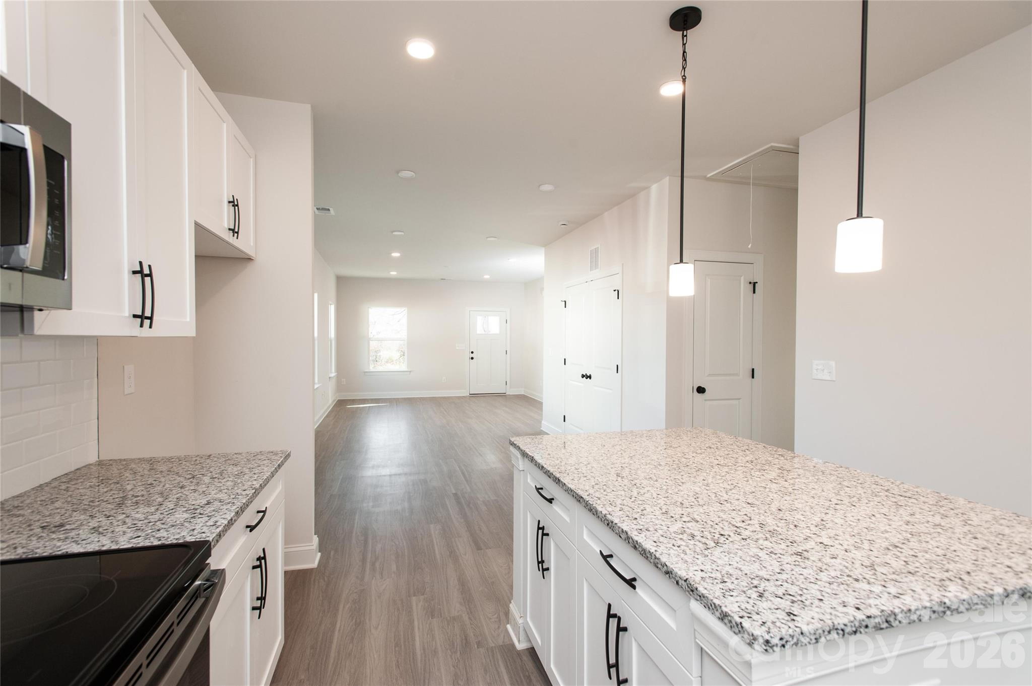 0 Lowesville Meadows Road Stanley, NC 28164 - Photo 12 of 25 a kitchen with a stove kitchen island and stainless steel appliances