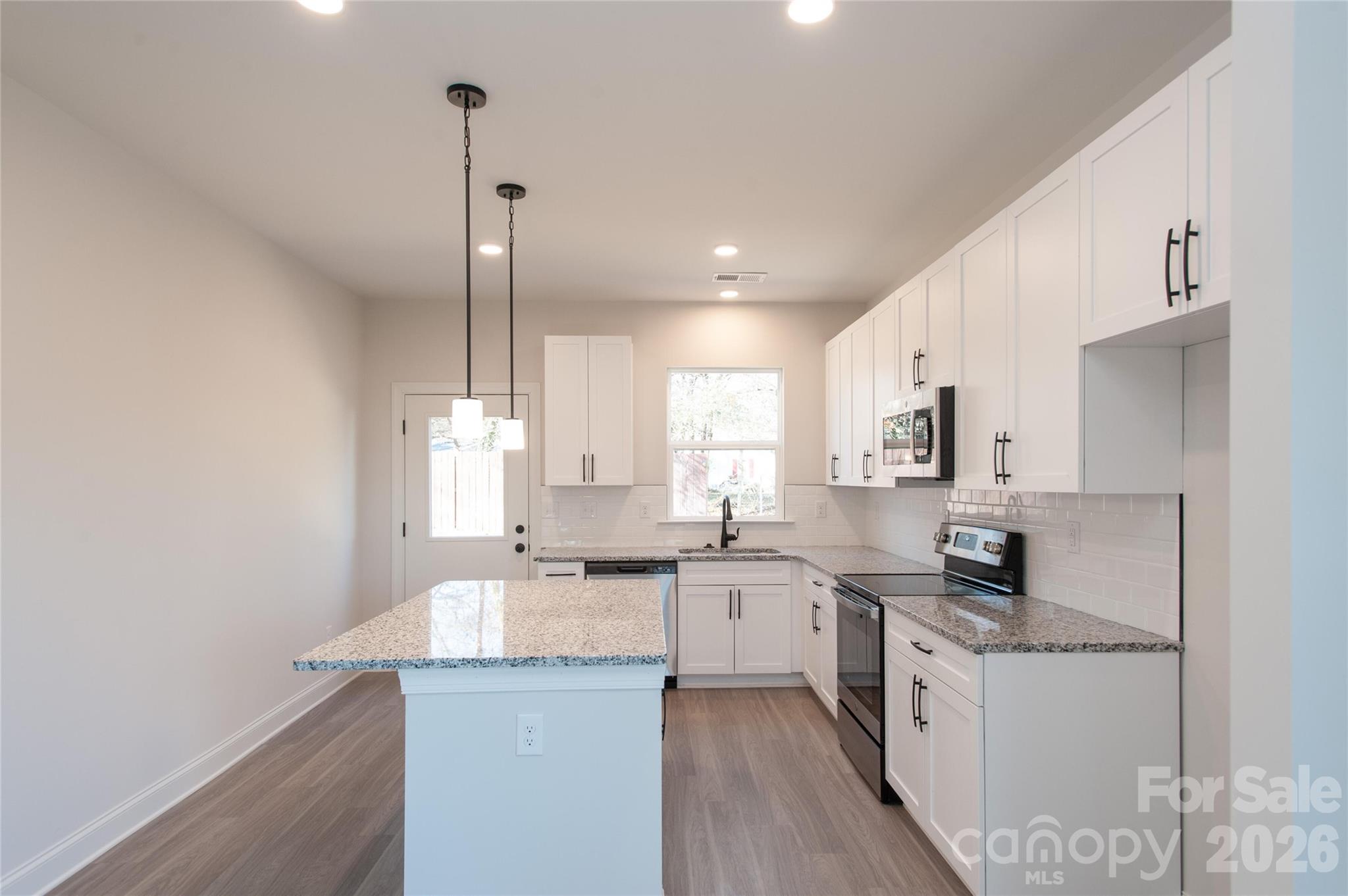 0 Lowesville Meadows Road Stanley, NC 28164 - Photo 6 of 25 a kitchen with granite countertop a sink appliances cabinets and furniture