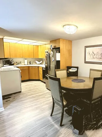 a kitchen with stainless steel appliances granite countertop a refrigerator a sink dishwasher and a stove top oven