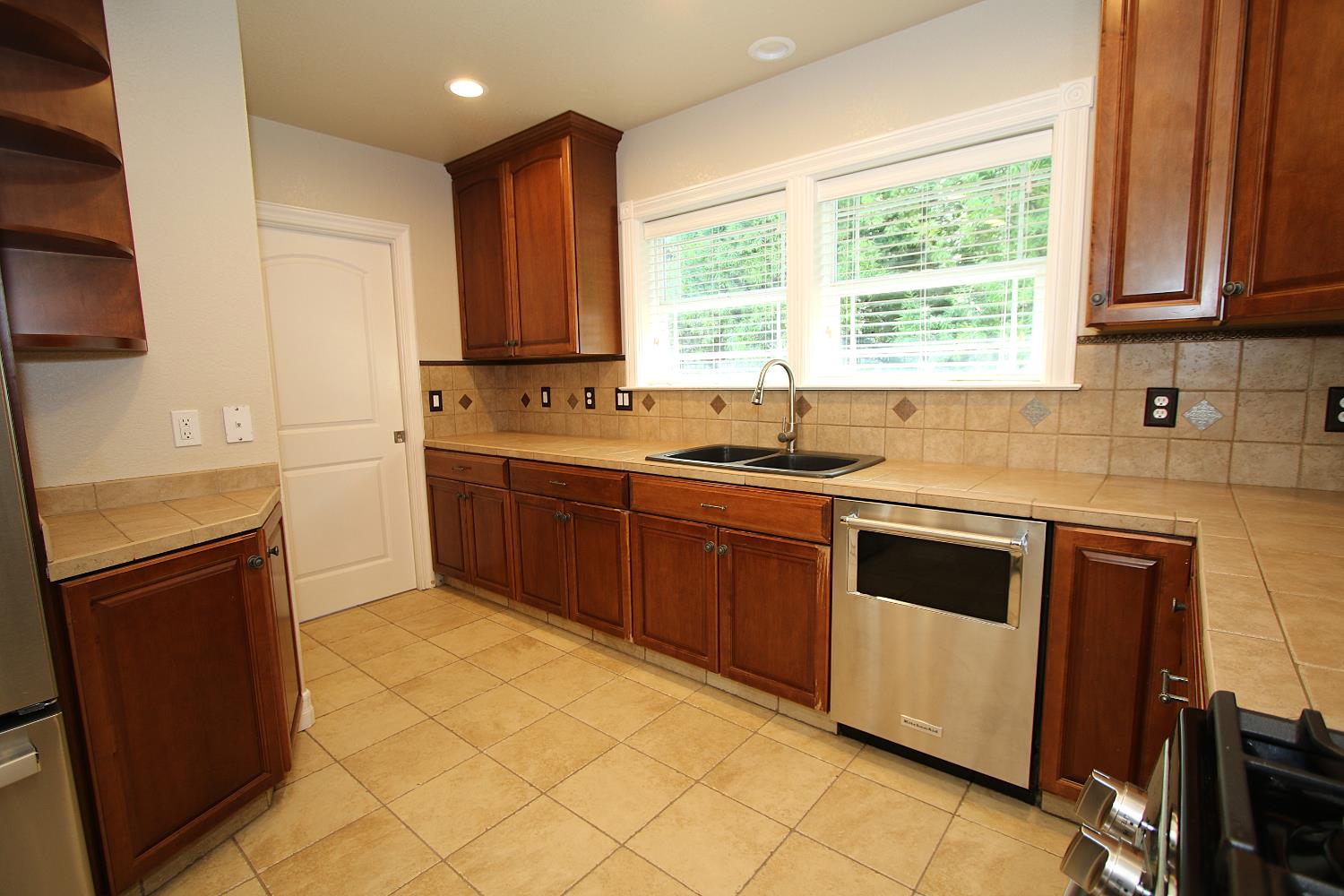 526 Melrose Street Modesto, CA 95354 - Photo 14 of 27 a kitchen with stainless steel appliances granite countertop a sink stove and refrigerator