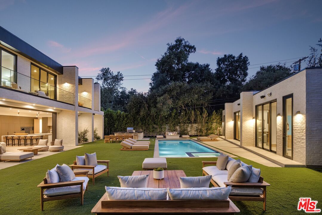17055 Rancho Street Encino, CA 91316 - Photo 70 of 73 a view of a swimming pool with lounge chairs in patio