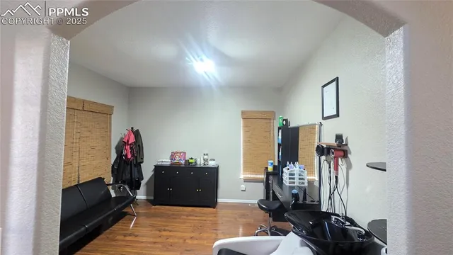 a living room with furniture and a gym equipment