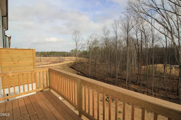 a view of a balcony with wooden floor