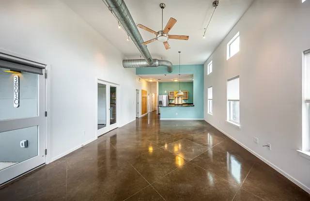 a view of a hallway with a ceiling fan