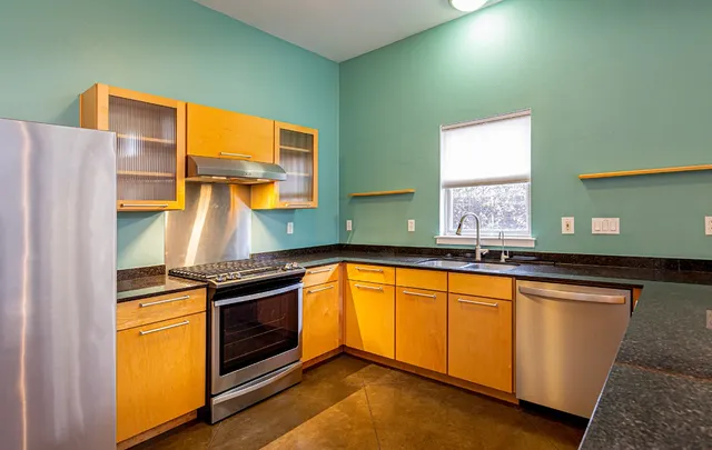 a stove top oven sitting inside of a kitchen