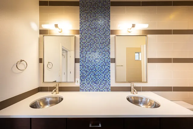 a bathroom with a sink double vanity and a mirror