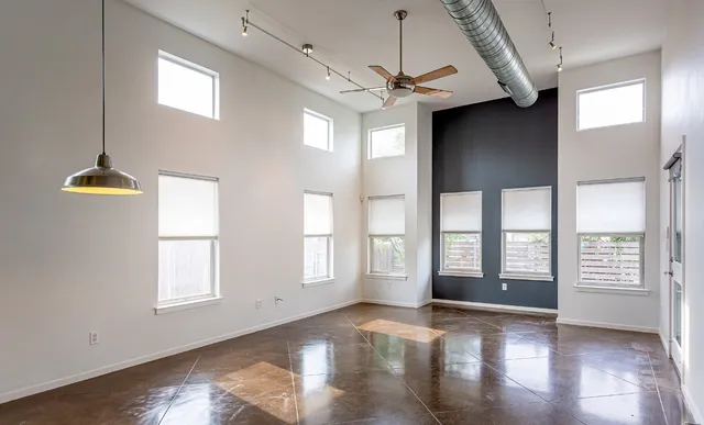 a view of a hallway view with wooden floor and a living room
