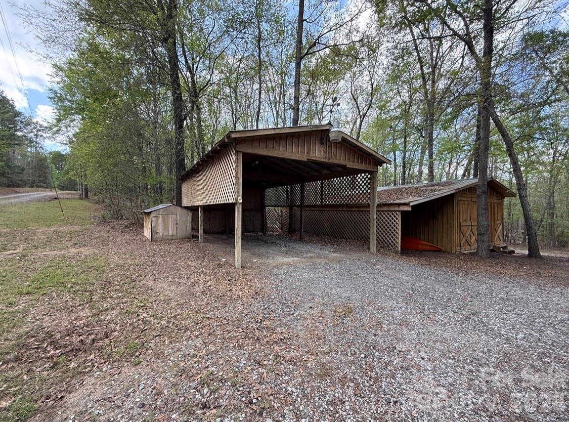 57 Club Lane Winnsboro, SC 29180 - Photo 29 of 48 a view of a wooden house with a yard and large trees