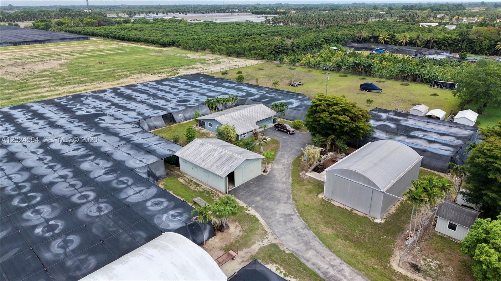 17355 Southwest 256th Street Homestead, FL 33031 - Photo 25 of 32 an aerial view of a house with a garden and lake view