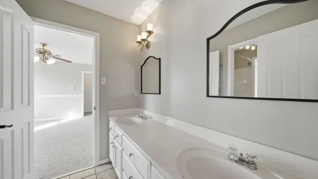 a bathroom with a granite countertop sink vanity and mirror