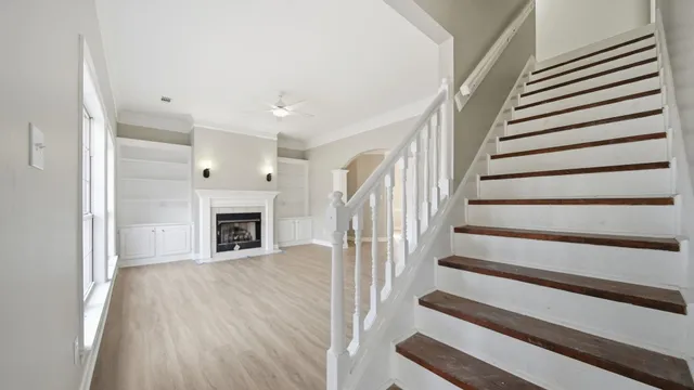 a view of a livingroom with a staircase and a fireplace