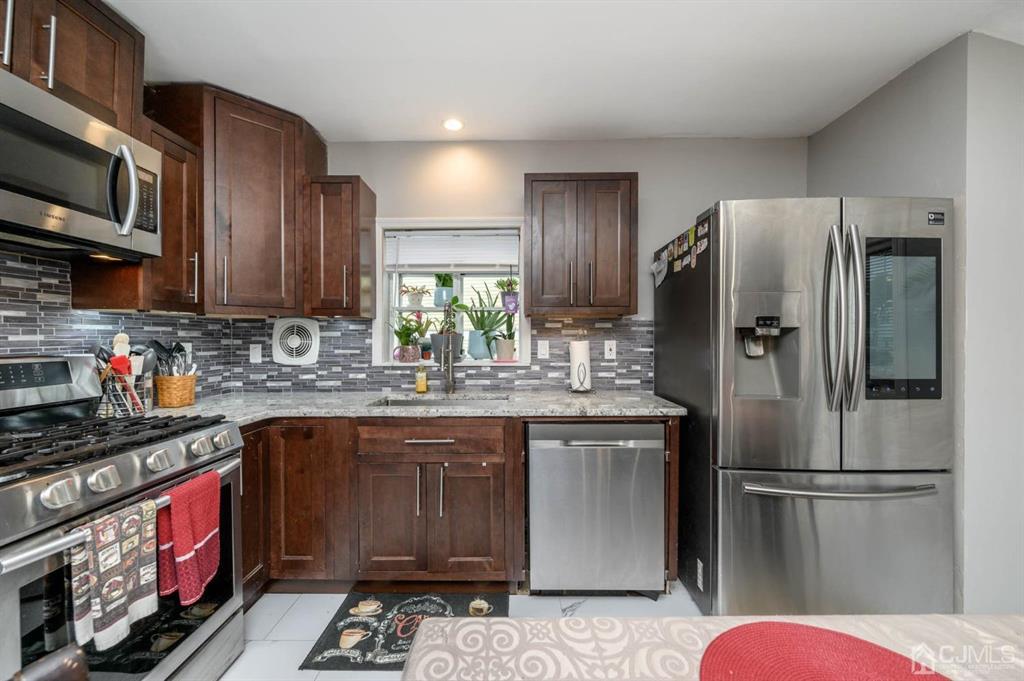 22 Vista Road Hamilton, NJ 08690 - Photo 11 of 38 a kitchen with stainless steel appliances granite countertop a refrigerator stove and microwave