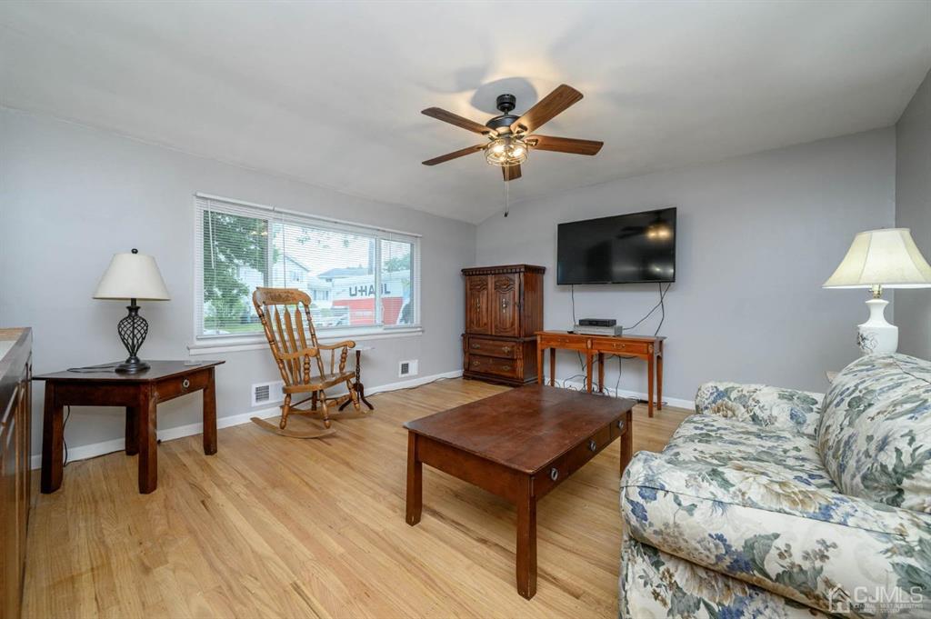 22 Vista Road Hamilton, NJ 08690 - Photo 4 of 38 a living room with furniture and a flat screen tv with wooden floor