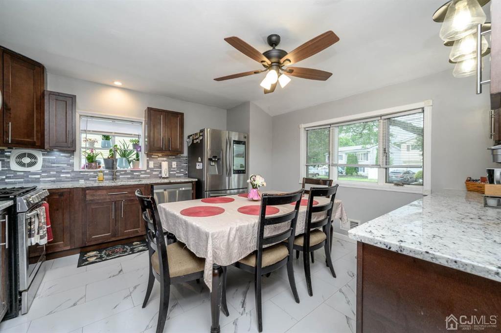 22 Vista Road Hamilton, NJ 08690 - Photo 7 of 38 a dining room with a table chairs and a kitchen view