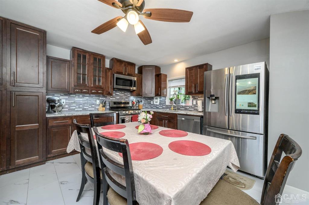 22 Vista Road Hamilton, NJ 08690 - Photo 8 of 38 a kitchen with a dining table and chairs