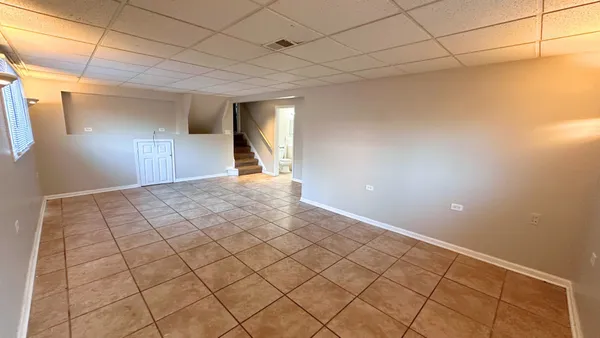 a view of a livingroom with an empty space and a window