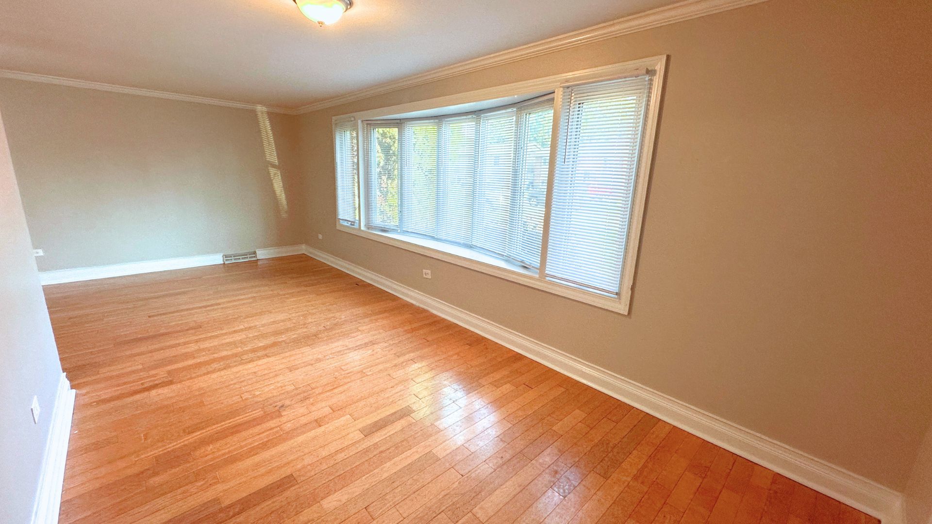 3416 West 124th Street Alsip, IL 60803 - Photo 3 of 19 an empty room with wooden floor and windows