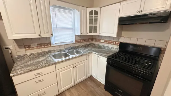 a kitchen with granite countertop cabinets and steel stainless steel appliances