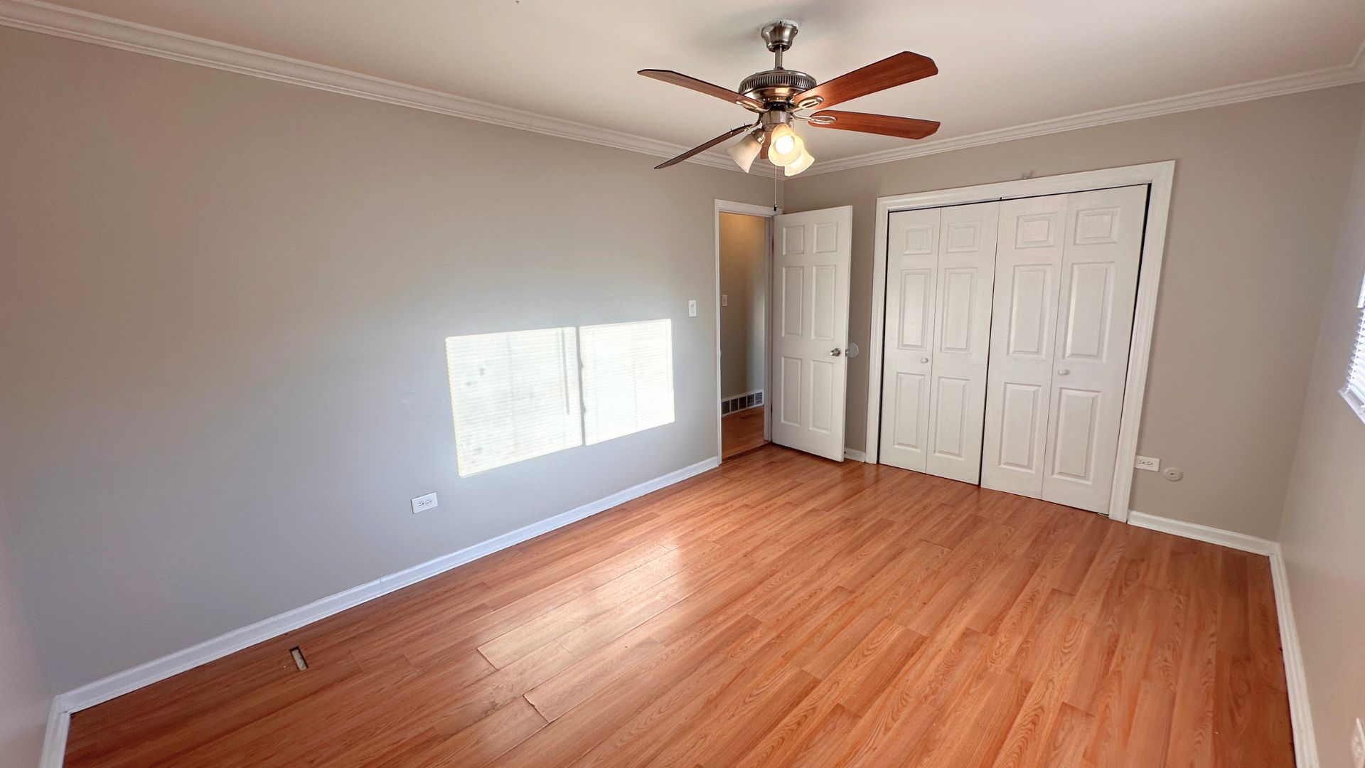 3416 West 124th Street Alsip, IL 60803 - Photo 7 of 19 an empty room with wooden floor and windows