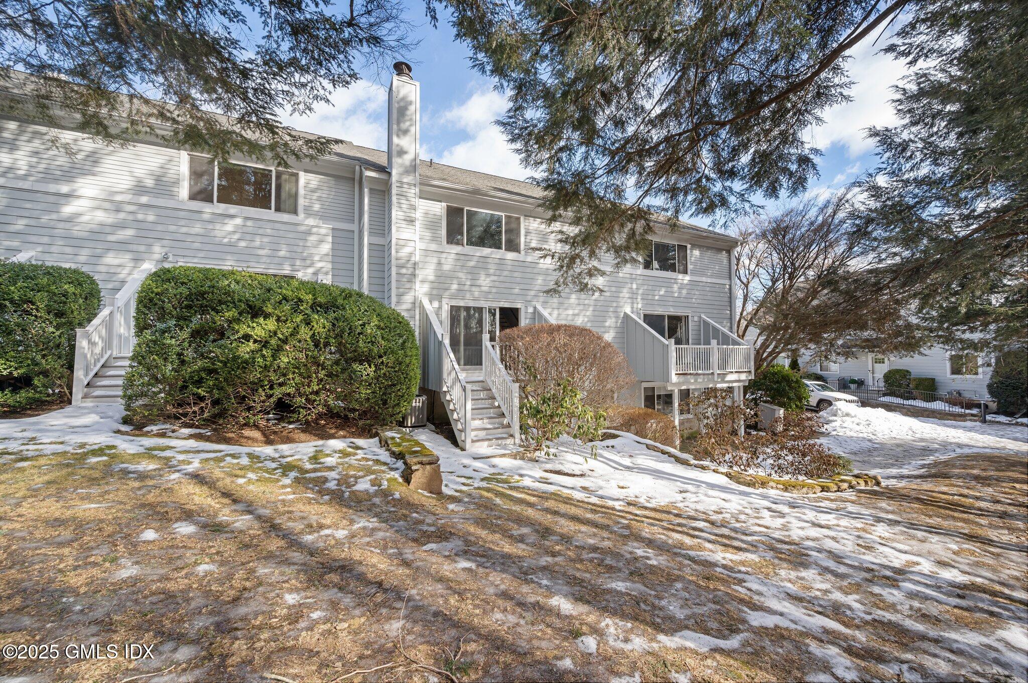 40 Silo Circle Riverside, CT 06878 - Photo 15 of 45 a view of a house with a yard covered in snow