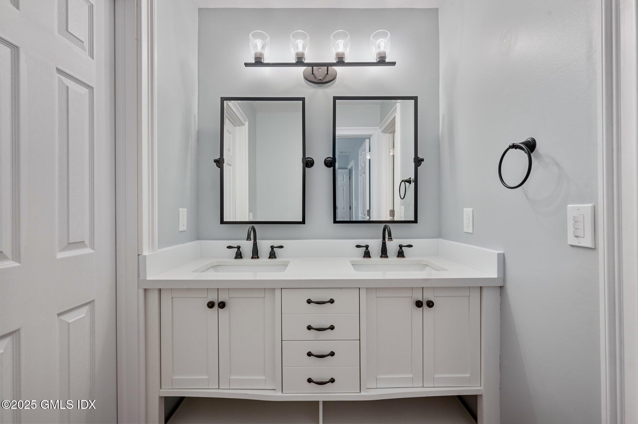 40 Silo Circle Riverside, CT 06878 - Photo 19 of 45 a bathroom with double vanity sinks and a mirror