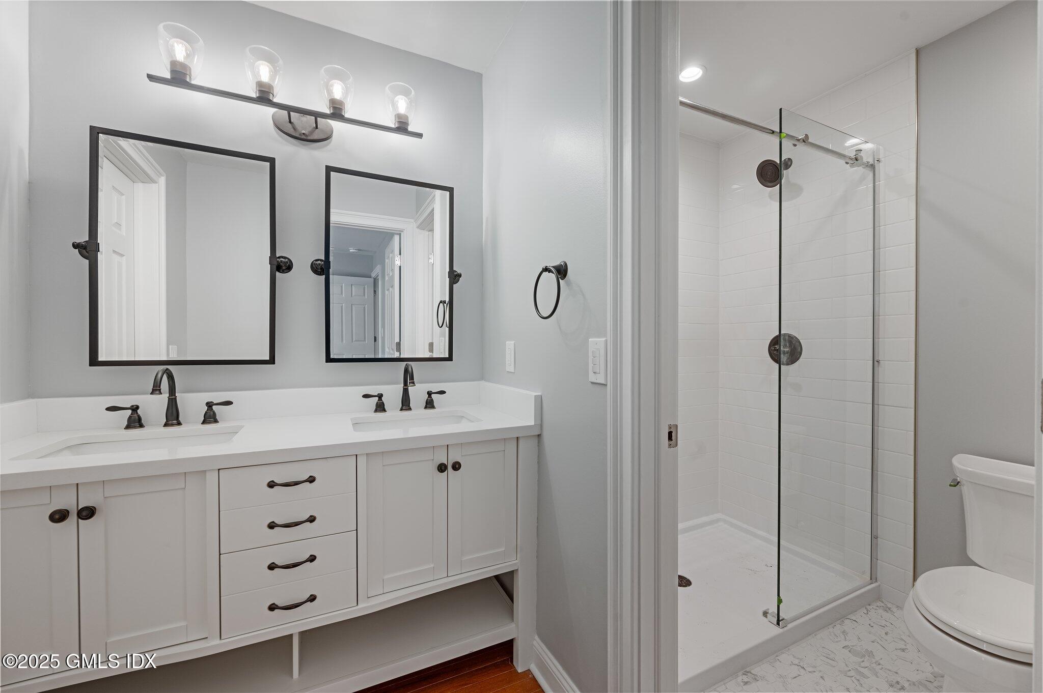 40 Silo Circle Riverside, CT 06878 - Photo 20 of 45 a bathroom with a toilet a sink a mirror a vanity and shower