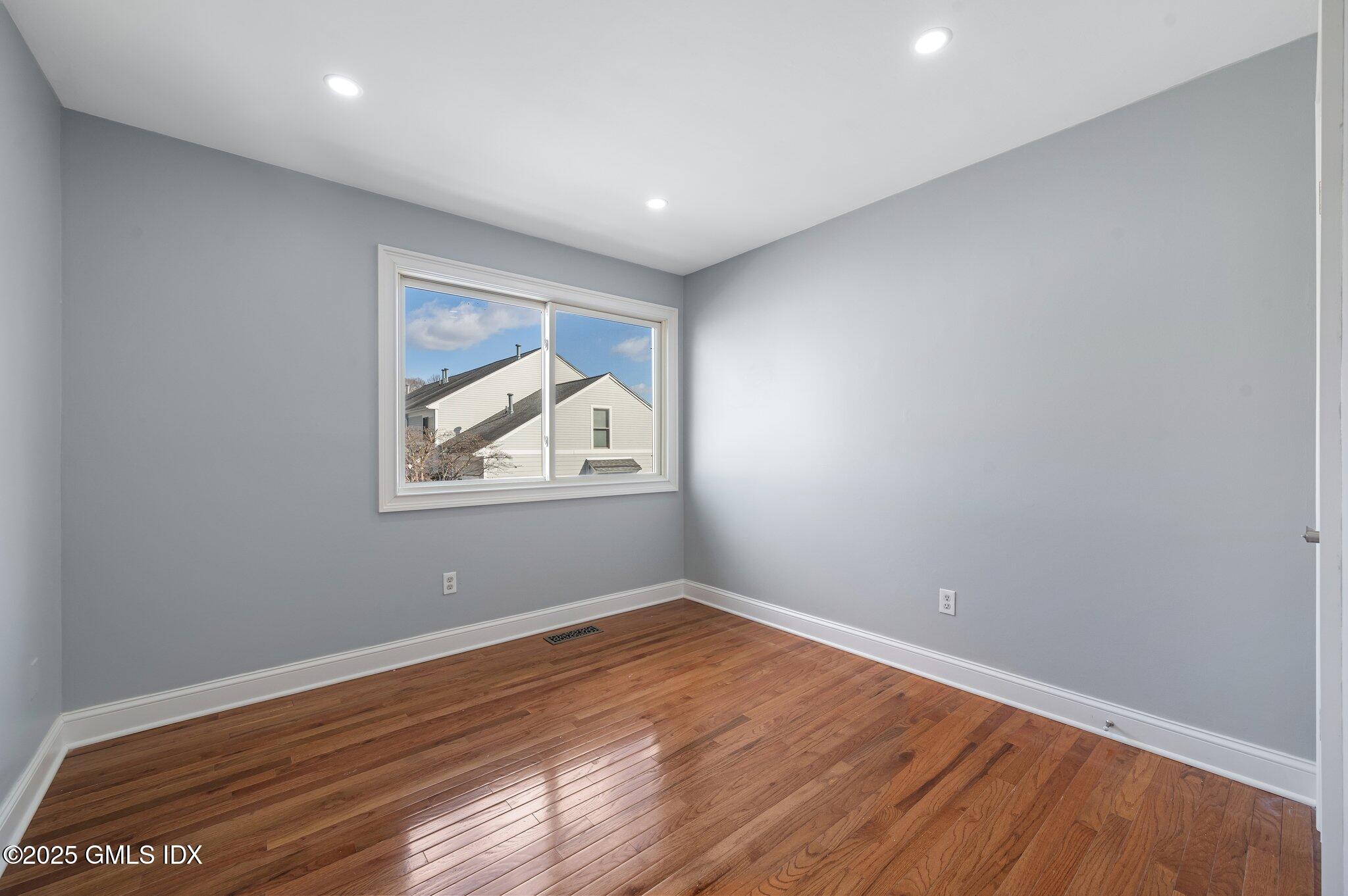 40 Silo Circle Riverside, CT 06878 - Photo 23 of 45 a view of empty room with wooden floor and fan
