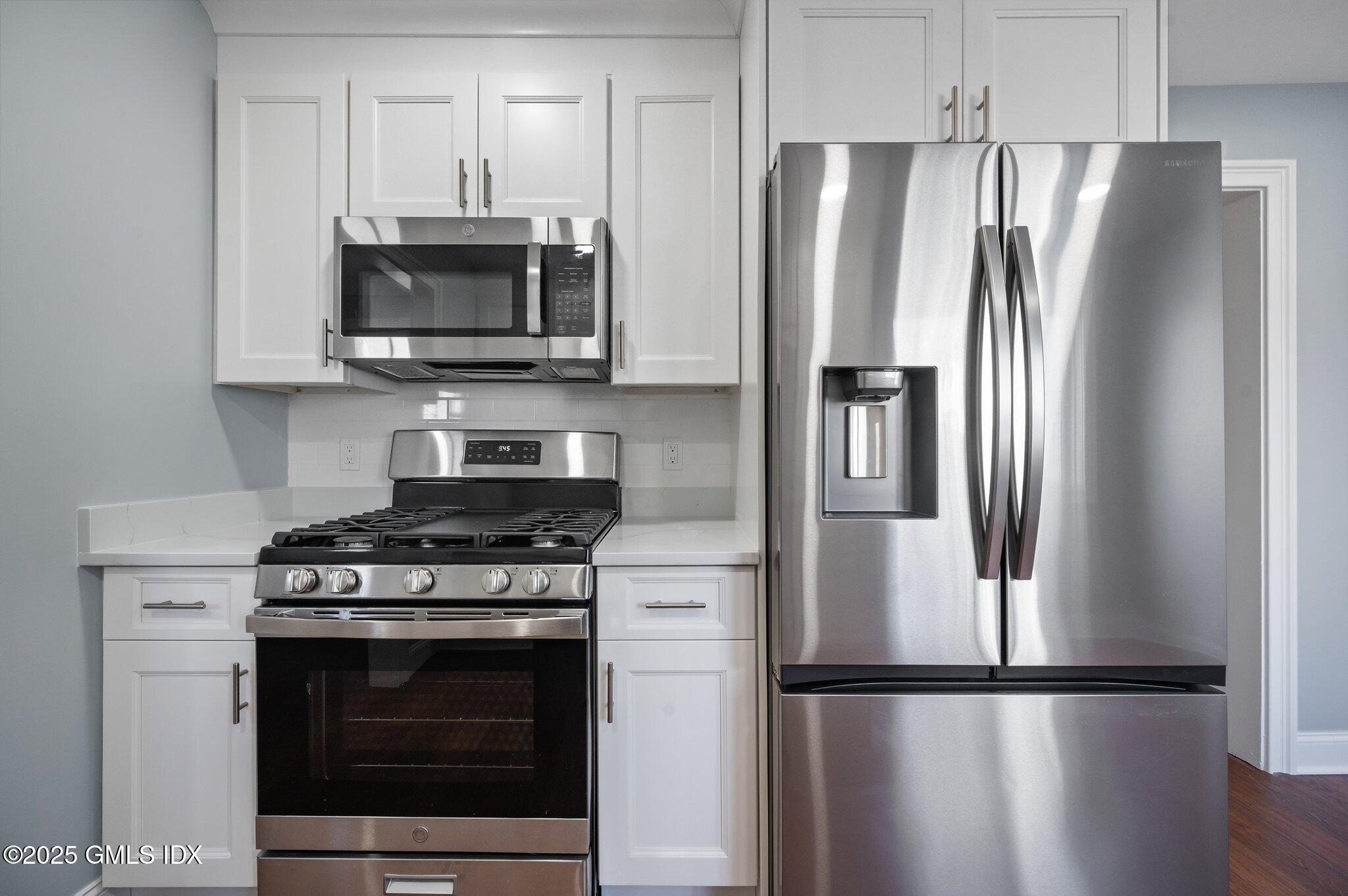 40 Silo Circle Riverside, CT 06878 - Photo 8 of 45 a kitchen with stainless steel appliances wooden floor sink and microwave