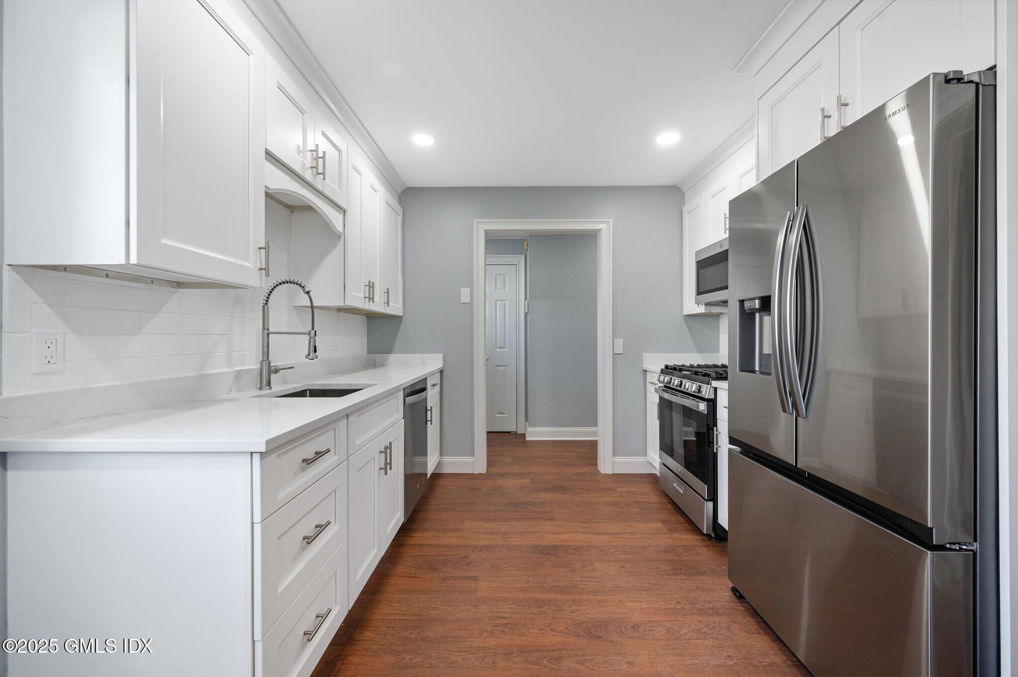 40 Silo Circle Riverside, CT 06878 - Photo 9 of 45 a kitchen with stainless steel appliances granite countertop a refrigerator a sink and a stove