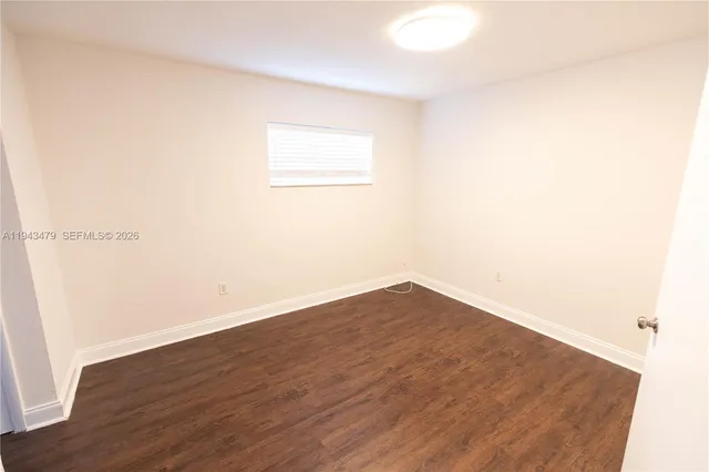 an empty room with wooden floor