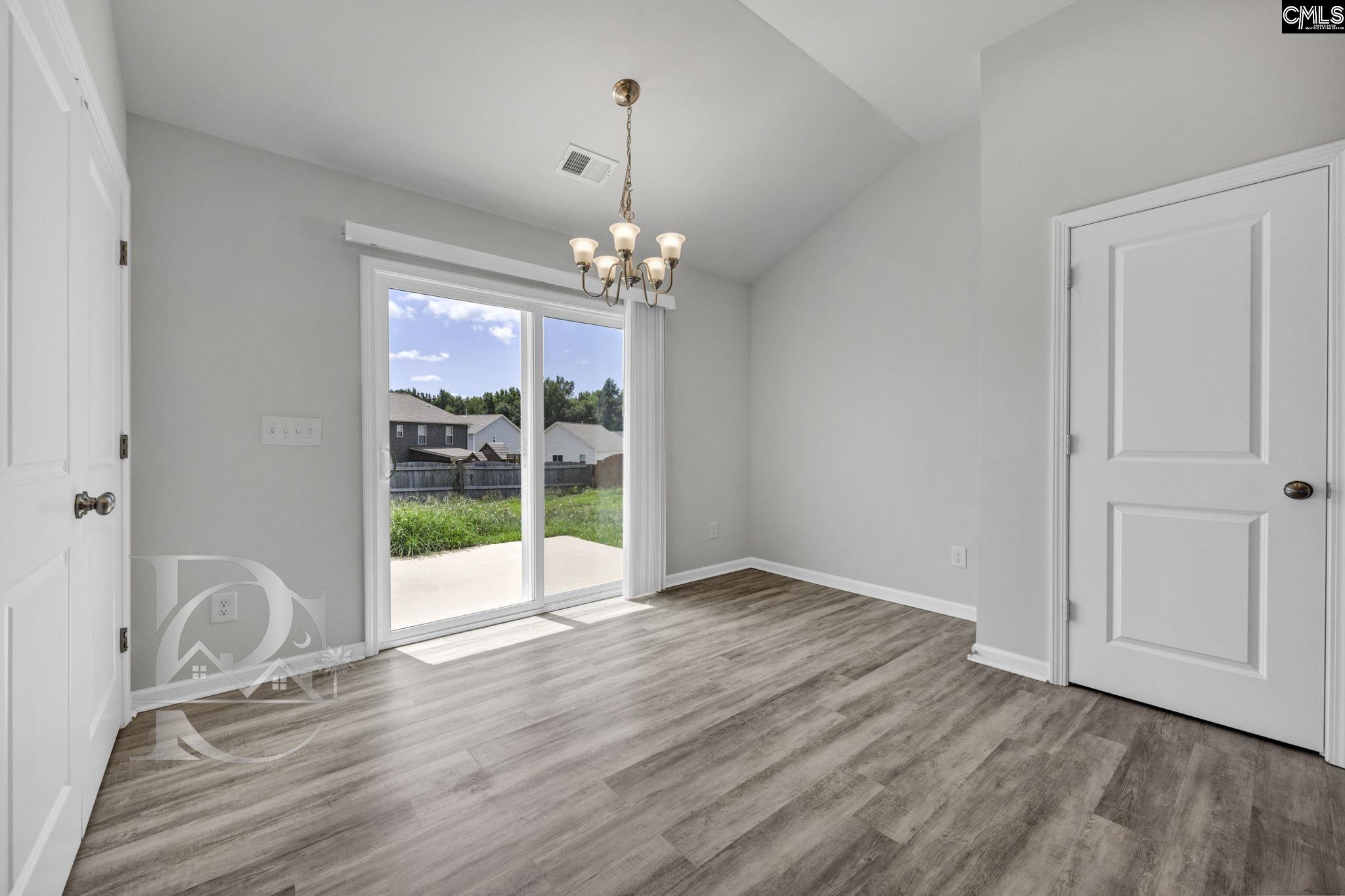 235 Drayton Hall Road West Columbia, SC 29172 - Photo 11 of 24 a view of an empty room with wooden floor and a window