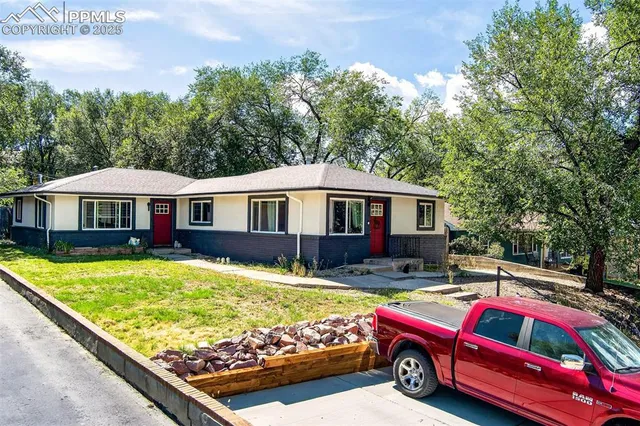 a view of a house with pool and a yard