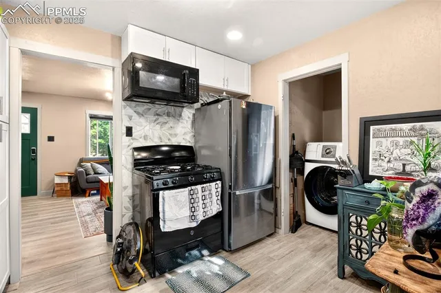 a kitchen with stainless steel appliances a stove a refrigerator and a wooden cabinets