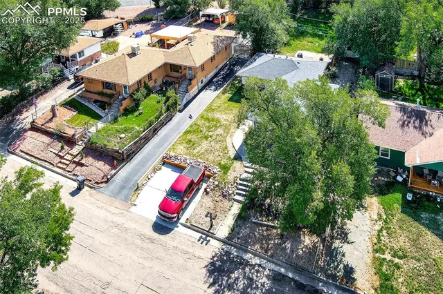 an aerial view of a house with an outdoor space